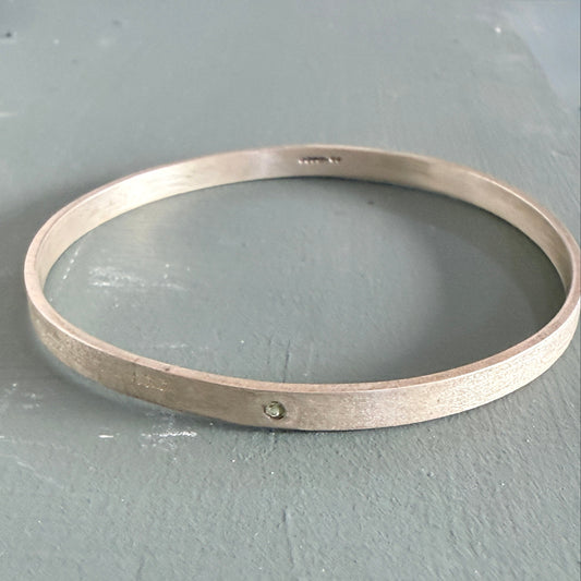 Sterling Silver Bangle on a gray surface