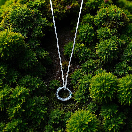 Necklace with a circular pendant on a green mossy background