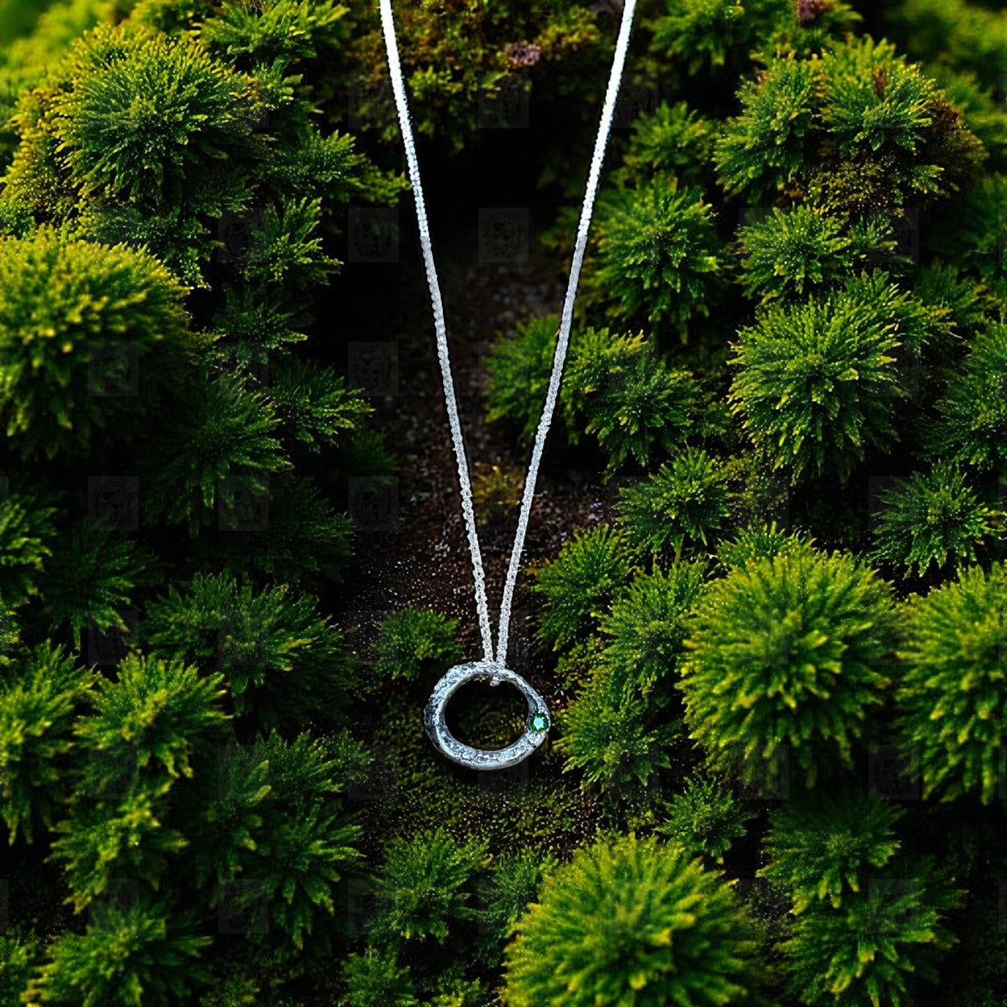 Necklace with a circular pendant on a green mossy background