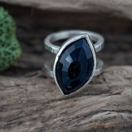 Tourmaline cocktail ting on a wooden surface with moss
