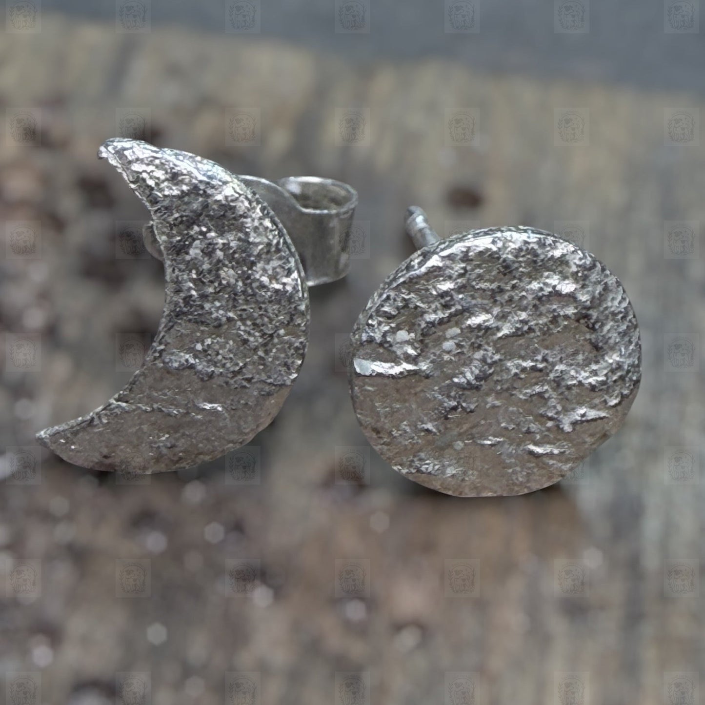 Silver textured moon and circle earrings on a wooden surface