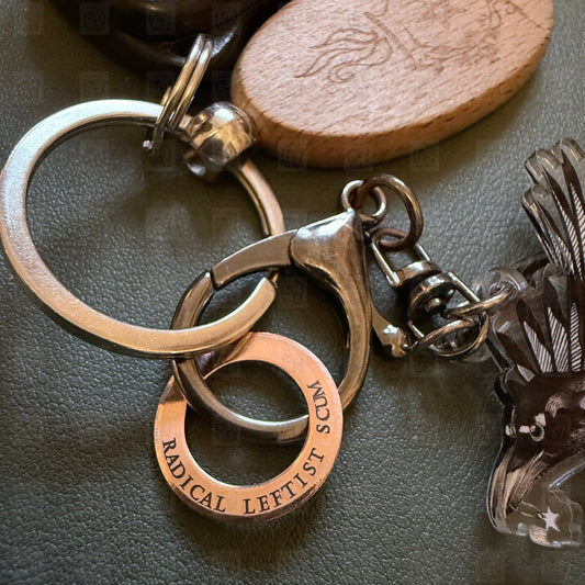 Keychain with engraved metal tag on a dark surface