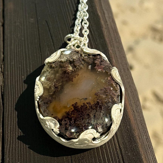 Necklace with a pendant on a wooden surface